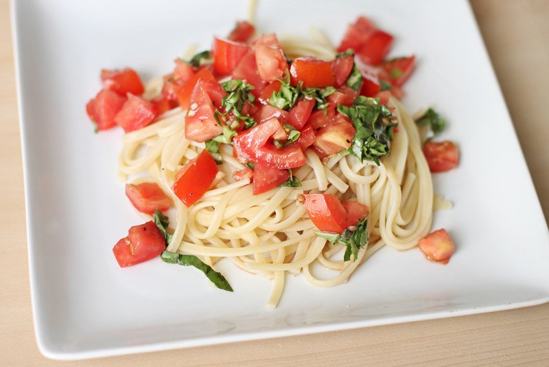 Tomato Basil Pasta served with fresh basil and Parmesan cheese